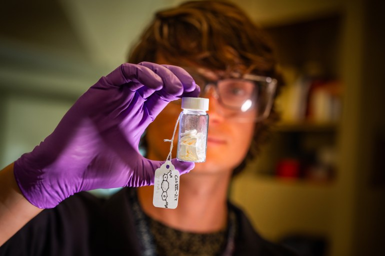 Eric Nagel showing the latest batch of material developed by his team at Sandia National Laboratories as they work to reproduce a molecule that changes the traditional behavior of polymers. (Photo by Craig Fritz)