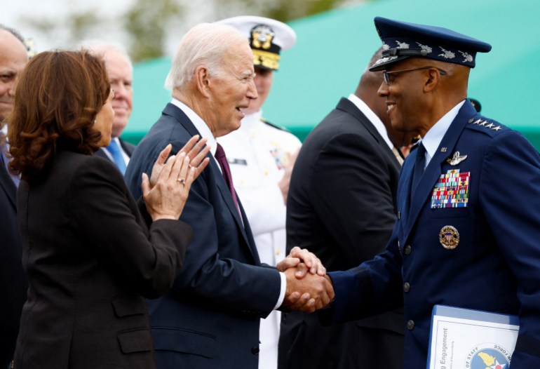 21st Chairman of the Joint Chiefs of Staff General Charles Q. Brown, Jr. shakes hands with U.S. President Joe Biden, as Vice President Kamala Harris reacts, on the day of the Armed Forces Farewell Tribute in honor of General Milley and an Armed Forces Hail in honor of General Brown, at Summerall Field at Joint Base Myer-Henderson Hall, Arlington, Virginia, U.S., September 29, 2023. REUTERS/Evelyn Hockstein