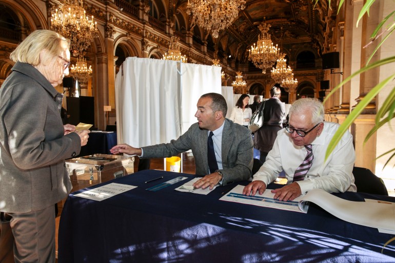 A woman casts his ballot during French Senate elections at the Hotel de Ville of Paris on September 24, 2017. Half of the seats in the upper house are up for grabs in the indirect election, in which only elected lawmakers -- parliamentarians, mayors, local councillors -- can vote.