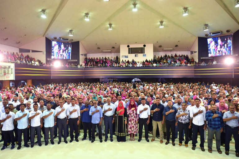 Maldives' President-elect of the Maldives' Mohamed Muizzu (C) of the People's National Congress (PNC) party stands with attendees as he attends a gathering with supporters following the country's presidential election, in Male on October 2, 2023. - Pro-China candidate Mohamed Muizzu won September 30's presidential election in the Maldives, a result set to once again upend the archipelago's relationship with traditional benefactor India. (Photo by Mohamed Afrah / AFP)