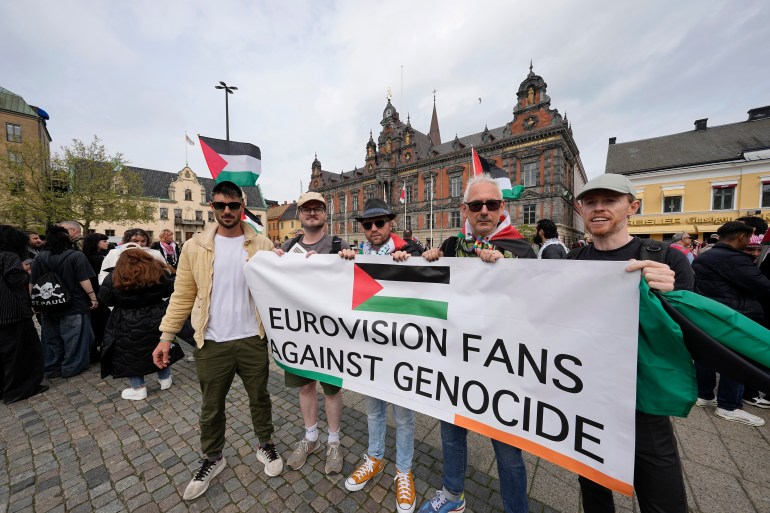 Protesters hold a banner during a Pro-Palestinian demonstration for excluding Israel from Eurovision ahead of the second semi-final at the Eurovision Song Contest in Malmo, Sweden, Thursday, May 9, 2024. (AP Photo/Martin Meissner)