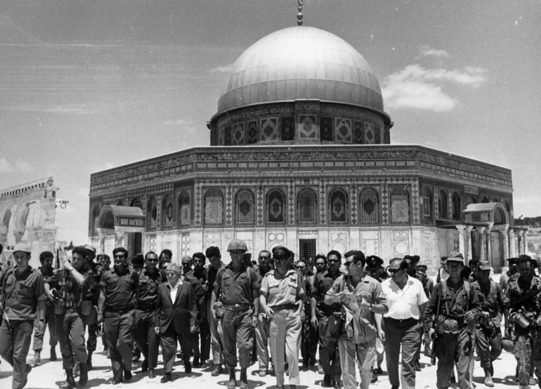 June 1967: Israeli statesmen David Ben-Gurion (1886 - 1973) and Yitzhak Rabin (1922 - 1995) lead a group of soldiers past the 'Dome of the Rock' on the Temple Mount, on a victory tour following the Six Day War, Old Jerusalem, Israel. (Photo by Hulton Archive/Getty Images)