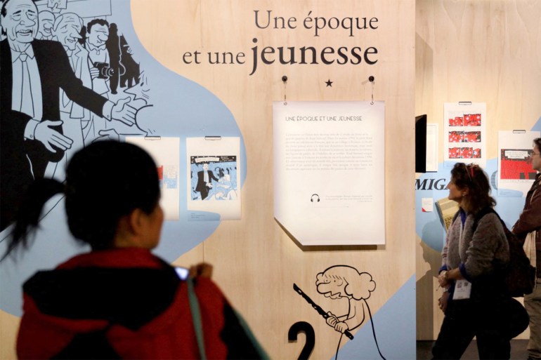 Visitors look at creations on display at the Riad Sattouf exhibition at Vaisseau Moebius during the 51st Angouleme International Comics Festival in Angouleme, western France, on January 24, 2024. (Photo by YOHAN BONNET / AFP)