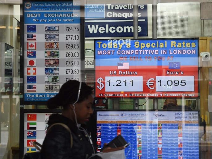 As the British pound sterling continues its Brexit-inspired slide against major currencies, a woman walks past a bureau of exchange in Victoria, central London late 12 October 2016 displaying the latest exchange rates.