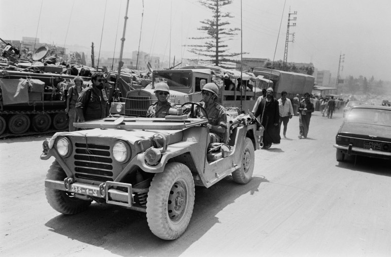 Israeli soldiers drive a jeep through the streets of the Lebanese port city of Sidon during the Israeli army invasion named "Operation Peace for the Galilee" in Sidon, Lebanon, in June 1982. (Photo by Bryn Colton/Getty Images)