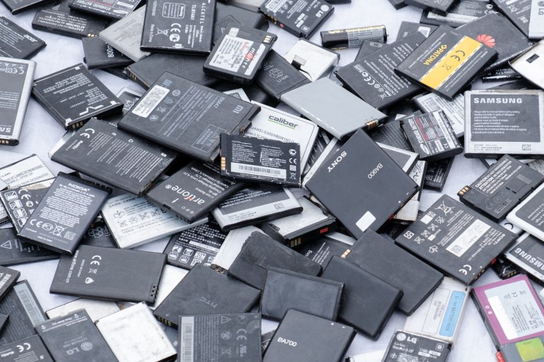 Prague, CZ 25 April 2021: Used cell mobile phone different brands batteries in the market. lot of Lithium rechargable Recycling lithium. EDITORIAL