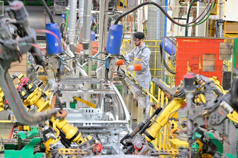 A worker assembles vehicle parts on a production line inside Renault factory, on the outskirts of Tangier, Morocco, Monday, April 29, 2024. Morocco has grown into a car manufacturing juggernaut over the past fifteen years, positioning itself strategically between East and West as the automotive industry transitions to electric vehicles. The country supplies more cars to Europe than China, India or Japan through new highways and an expanded port in Tangier. (AP Photo)