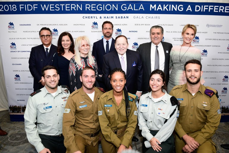 BEVERLY HILLS, CA - NOVEMBER 01: (Back Row, L-R) Andy Garcia, Fran Drescher, Dr. Miriam Adelson, Gerard Butler, Sheldon Adelson, Haim Saban, Cheryl Saban and IDF soldiers attend Friends of The Israel Defense Forces (FIDF) Western Region Gala at The Beverly Hilton Hotel on November 1, 2018 in Beverly Hills, California. (Photo by Shahar Azran/Getty Images)