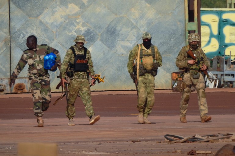 FILE - This undated photograph handed out by French military shows three Russian mercenaries, right, in northern Mali. Russia's Wagner Group, a private military company led by Yevgeny Prigozhin, a rogue millionaire with longtime links to Russia's President Vladimir Putin, has played a key role in the fighting in Ukraine and also deployed its personnel to Syria, Central African Republic, Libya and Mali. (French Army via AP, File)