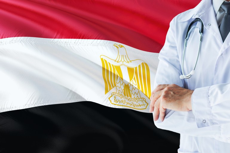 Egyptian Doctor standing with stethoscope on Egypt flag background. National healthcare system concept, medical theme.