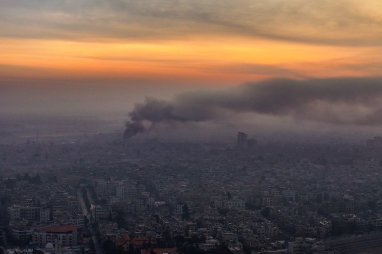 An aerial picture shows smoke billowing following airstrikes in Damascus early on December 10, 2024. - The Syrian Observatory for Human Rights said on December 10 it had recorded more than 300 Israeli strikes since Islamist-led rebels toppled the country's longtime ruler Bashar al-Assad over the weekend. (Photo by Omar HAJ KADOUR / AFP)